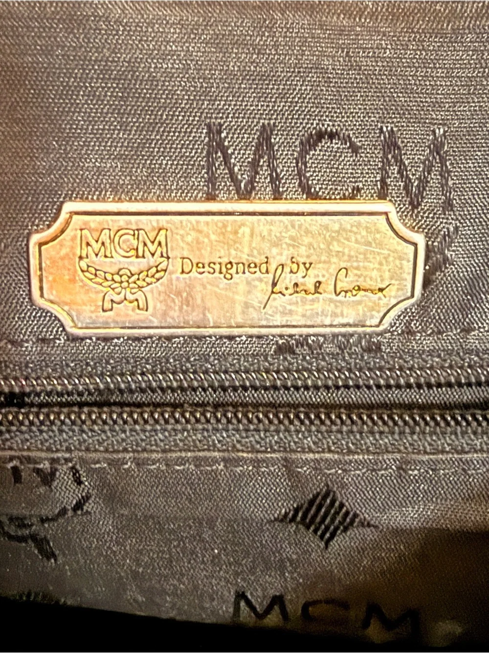 MCM Black Leather Backpack with Gold Accents and Front Pockets